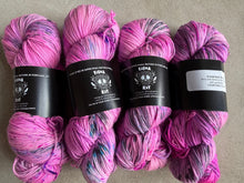 Load image into Gallery viewer, Four skeins of pink yarn with labels on a gray background